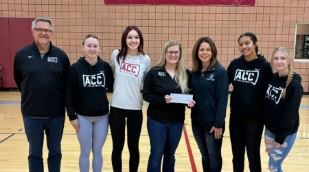 Community Foundation of Northeast Michigan Youth Advisory Council Members pose with a $505.00 check and posters advertising YAC Day